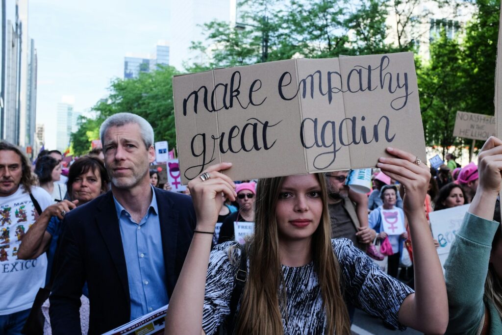a man and woman holding a sign