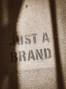 the shadow of a person standing in front of a sign